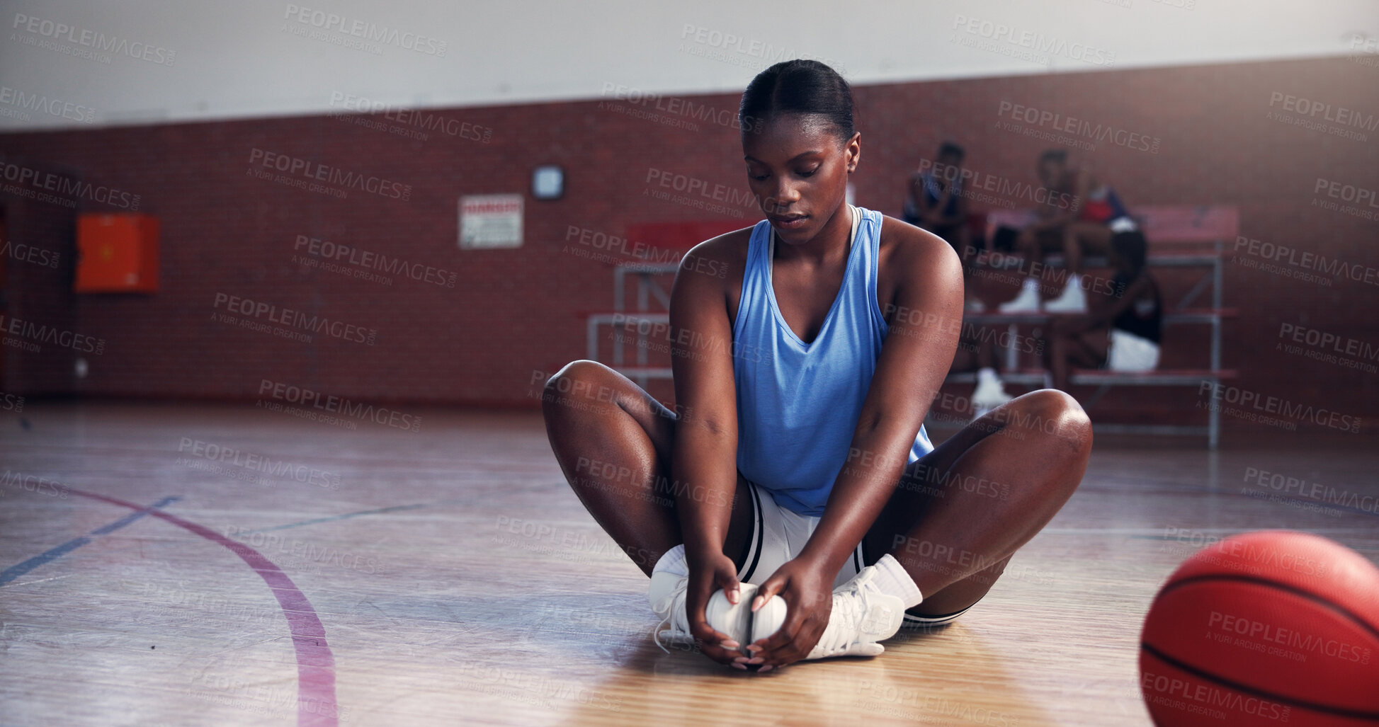 Buy stock photo Basketball player, girl and stretching legs for fitness, warm up or ready for game, league and playoffs. Black person, workout or start routine with ball for contest, competition or court with sports