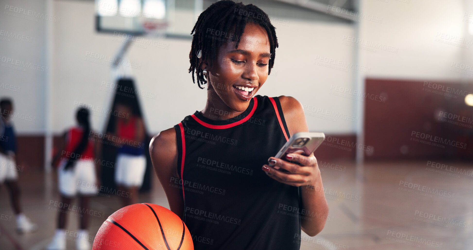 Buy stock photo Phone, smile and sports with basketball player on court for app, communication or social media. Break, fitness and training with happy woman in gymnasium for competition, exercise or performance