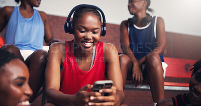 Buy stock photo Phone, reading and headphones with black woman on basketball court for sports progress, athlete scouting and streaming. Score tracking, training program and subscription with person and game updates