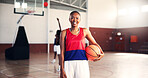 Basketball player, girl and happy in portrait at gym for fitness, confident and ready with training for competition. Woman, start and smile with pride for contest, workout and exercise at sports club