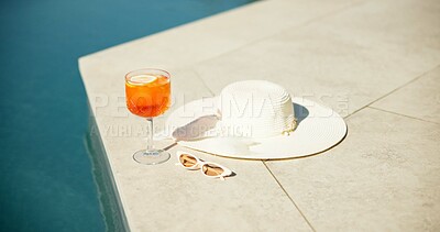 Buy stock photo Cocktail, alcohol and swimming pool with sunglasses and hat for summer holiday or vacation. Travel, resort and drink by water for outdoor luxury, hotel hospitality and break to relax or chill