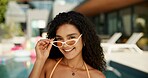 Portrait, outdoor and woman with vacation, sunglasses and smile with summer holiday. Accommodation, person and traveller with eyewear, style or resort with weekend break, shades or relax with fashion
