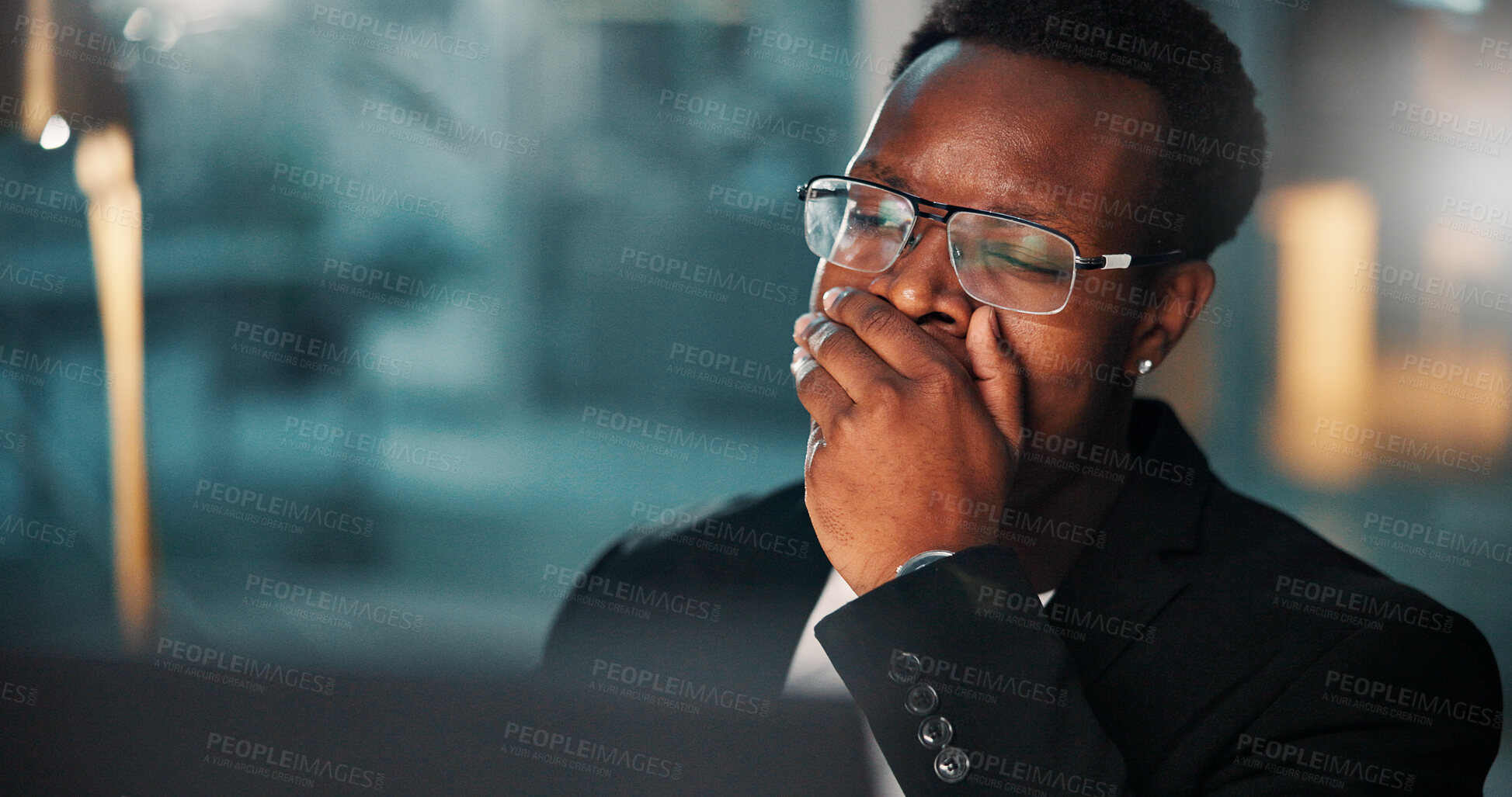 Buy stock photo Black man, tired and night with yawn, computer and burnout for evening deadline at office desk. African editor, exhausted employee and working late on PC in fatigue, overworked or sleepy with project