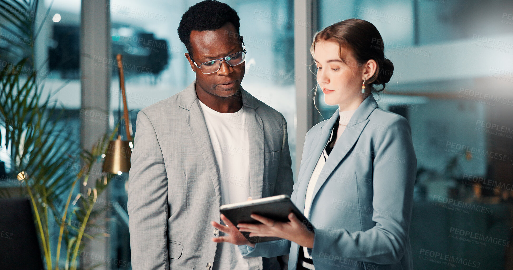 Buy stock photo Business people, tablet and team brainstorming at night for deadline, progress update or project management. Meeting, planning and discussion with tech in office for budget, schedule and development