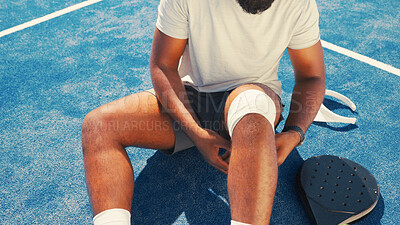 Buy stock photo Bandage, knee pain and man on tennis court with injury, medical crisis and accident outdoors. Fitness, health and person with ache, strain and hurt from training, workout and exercise for padel game
