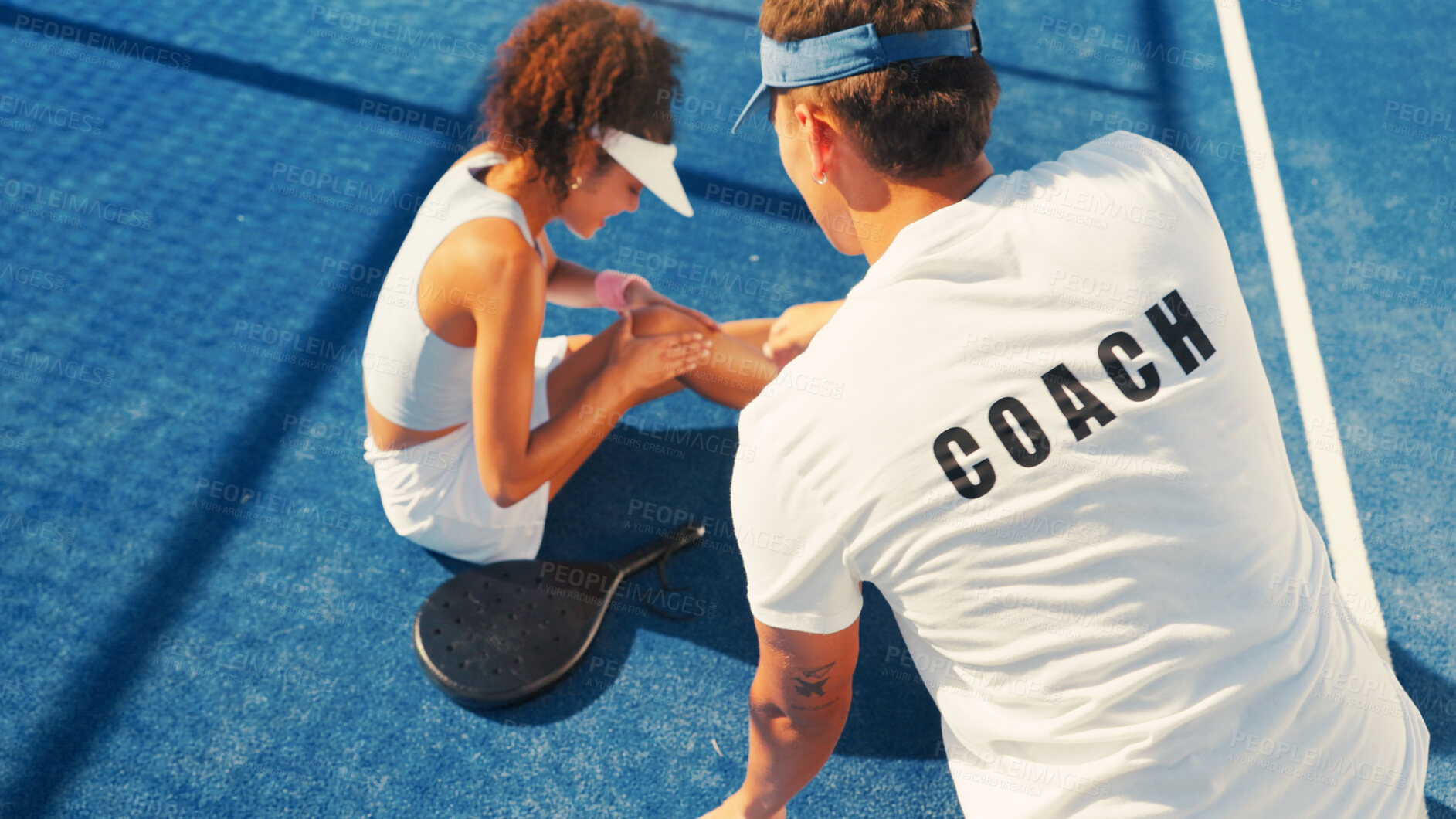 Buy stock photo Woman, sport and knee injury with coach for pain, medical assistance or help on outdoor court. Female person, paddle tennis or player with sore leg, bruise or joint inflammation for muscle sprain