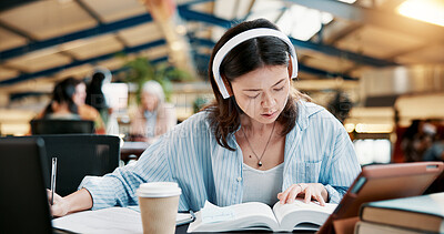 Buy stock photo Headphones, reading book and woman learning in university for knowledge, research or listening to audio. Writing notes, college and serious student study for exam, education or technology for music