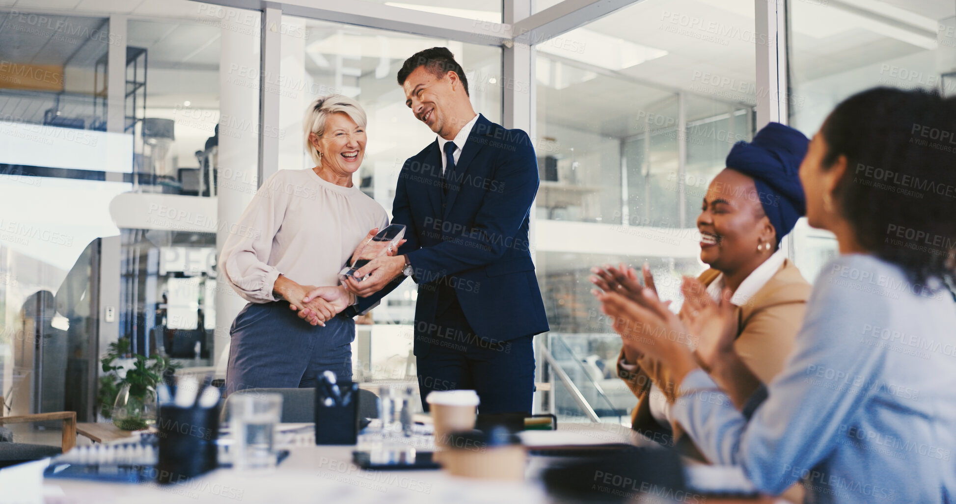 Buy stock photo Applause, winner and award with business people in meeting for trophy, achievement and deal. Promotion, congratulations and handshake with group of employees in office for profit, bonus and success