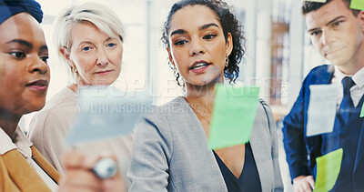 Buy stock photo Glass wall, ideas and writing with business people in office for collaboration or strategy. Brainstorming, planning and sticky notes with employee team in workplace for discussion or management