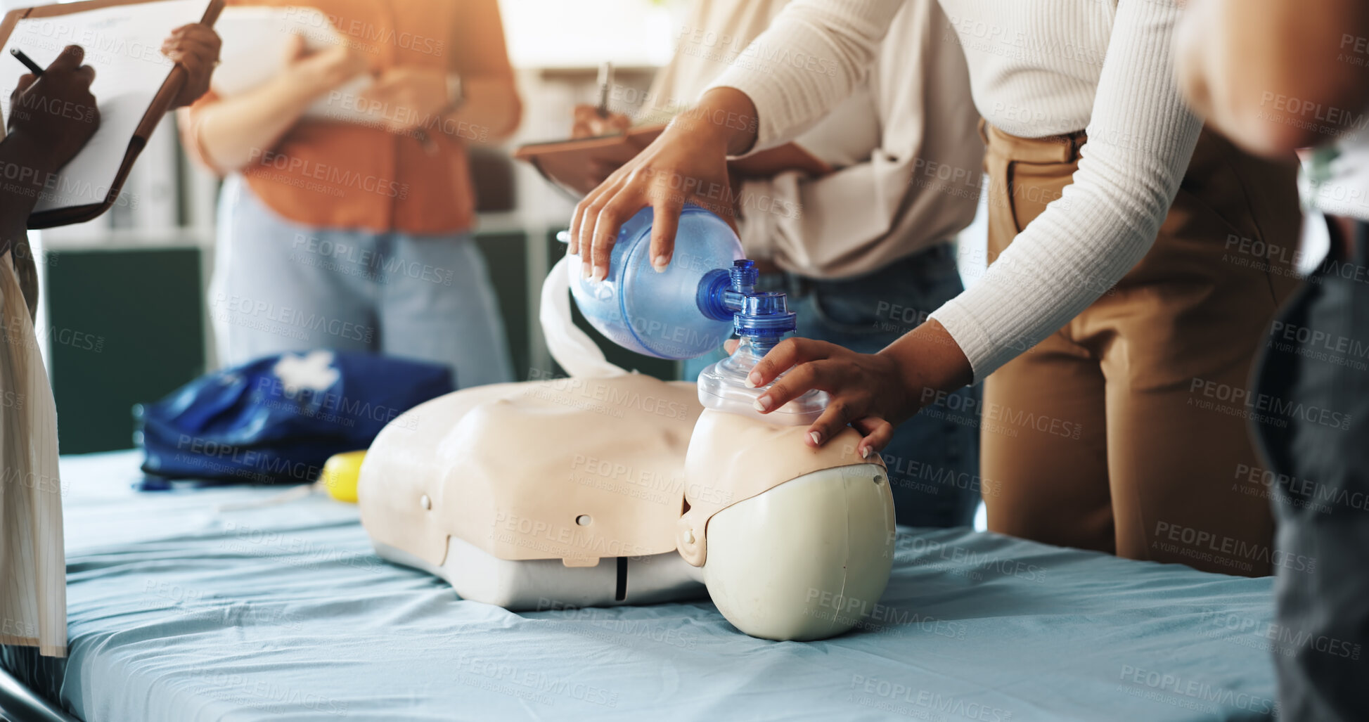 Buy stock photo Group, cpr and woman with mask, dummy and lesson to help in emergency, training and demonstration. Course, people and instructor with ventilator for mannequin, teaching and healthcare in class