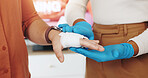 Bandage, clinic and nurse with patient for hand injury, hurt or accident  with emergency service. Healthcare, closeup and medical worker with person for cotton wrap for bruise, wound or muscle sprain