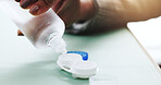 Hands, contact lens and bottle with liquid, eye care and closeup for cleaning solution or cosmetics. Optometry, wellness and person with prescription treatment, plastic case and visual improvement