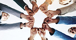Hands, business people and fist bump for teamwork, solidarity or cooperation below. Circle, collaboration and community of employees huddle for motivation, mission or support in office with low angle