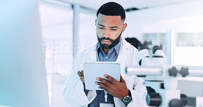 Buy stock photo Man, scientist and reading on tablet in lab for medical research, experiment results and study report. Male person, digital app and information of investigation feedback, discovery update and vaccine