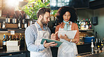 Online, entrepreneur and team with tablet, cafe and review of order for inventory, people or discussion. Small business, woman and man with tech for sales, clipboard or colleagues with app in startup