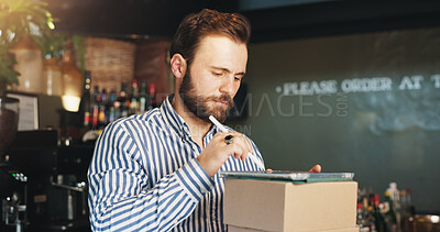 Buy stock photo Restaurant, boxes and man on tablet in cafe for menu items, inventory and order checklist at bar. Pub, hospitality and business owner on digital tech for internet, planning and review on website