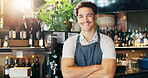 Man, waiter and arms crossed with smile at cafe with pride, confident and small business owner at restaurant. Person, barista and portrait with career, catering and happy at coffee shop in Costa Rica