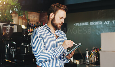 Buy stock photo Coffee shop, online and man on tablet in cafe for menu items, inventory and order checklist. Restaurant, hospitality and business owner on digital tech for internet, planning and review on website