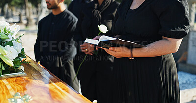 Buy stock photo Bible, flower and hands by coffin at funeral for respect, blessing or spiritual comfort at graveyard. Religion, reading and woman by casket with white rose and holy book for grief, loss or farewell.