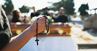 Buy stock photo Funeral, hands and person with rosary, death and symbol for religious service, respect and graveyard. Outdoor, prayer and Christian with crucifix necklace for sermon, faith and gospel in cemetery