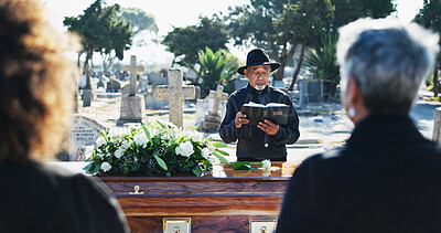 Buy stock photo Bible, coffin and priest by graveyard with family for spiritual farewell, grief or loss. Religion, casket and pastor with people for memorial service at burial with holy book for blessing or goodbye.