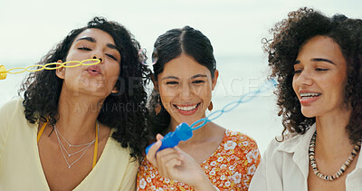 Buy stock photo Friends, people and blowing bubbles at beach for holiday activity, travel adventure and fun bonding game. Women, happy and freedom with toy wand for vacation support, weekend break and enjoyment