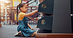 Shelf, choice and child with books in library for reading story, literature and learning. School, bookstore and girl on floor with decision or search for knowledge, education and language development