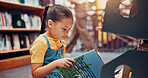 Girl, child and reading book in library, relax and smile with fantasy, education and novel. School, student and academic growth for development, storytelling and knowledge with vocabulary or learning