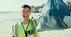 Happy man, portrait or volunteer with bag on beach for recycling, eco friendly environment or earth day. Male person, activist or community service with smile or dirt for save planet or world charity