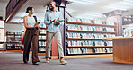 University, happy friends and students talking in library with books for exam discussion, results or laugh. People, education and college team in bookstore for funny joke, walk or learning knowledge