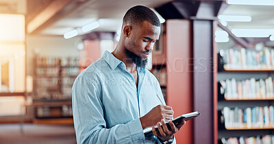 Buy stock photo Education, college and man with tablet in library for knowledge, reading or study. African student, digital technology and research in university with pen for thesis, writing notes or learning online