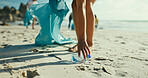Hands, plastic bottle and cleaning beach for pollution, bag and accountability with dirt in environment. Person, volunteer and legs with trash, rubbish and garbage on earth day by ocean in summer