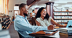 University, laugh and students in library on laptop for online research, information and studying for project. College, friends and man and woman with books for education, knowledge and learning