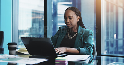 Buy stock photo Black woman, laptop and typing with documents for business research, planning or design at office desk. Female person, computer and paperwork with internet for project, schedule or tasks at workplace
