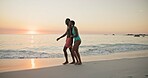 Smile, black couple and laugh for walk on beach of summer vacation, tropical journey and romantic date. Happy, people and holding hands for ocean travel, commitment and funny joke for getaway holiday