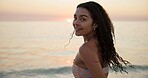 Happy, ocean and portrait of woman on beach for tropical vacation, getaway or holiday. Smile, outdoor and female person from Mexico by sea waves for weekend trip with peace and calm in evening.