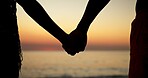 Love, silhouette and holding hands with couple at beach for romance, connection or honeymoon vacation. Support, trust and sunset date with closeup of people in nature for bonding, commitment and trip
