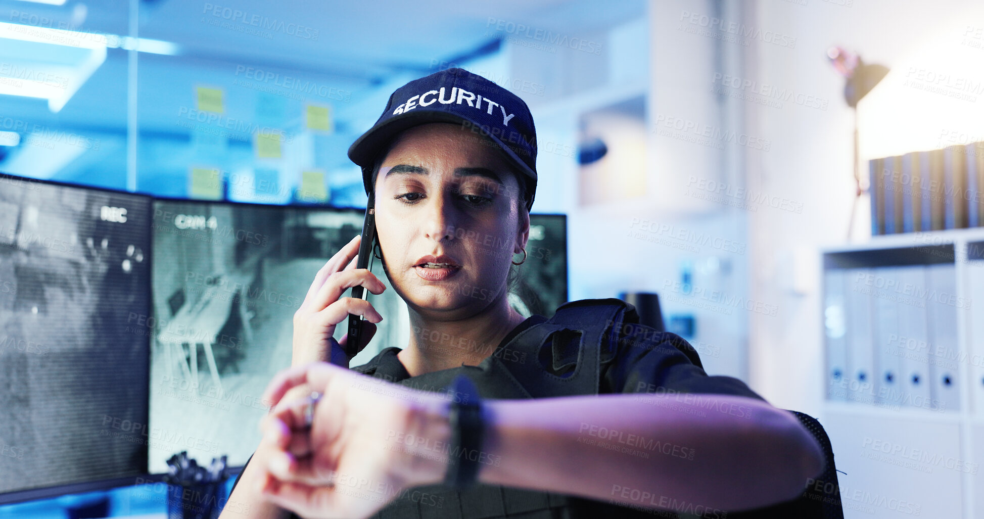 Buy stock photo Security, control room and woman with phone call, time and contact report at computer screen. CCTV, night surveillance and officer checking watch, communication and intelligence at command center