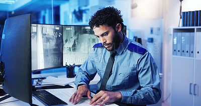 Buy stock photo CCTV, computer screen and security with man in office at night for monitoring, protection or safety. Dispatch, law enforcement and surveillance with police officer at desk for government career
