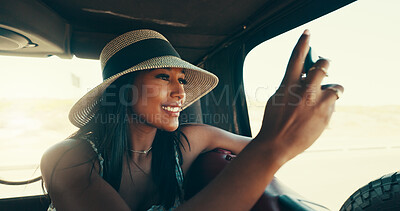 Buy stock photo Road trip, photography and woman with smartphone, car and sightseeing of desert, travel and summer holiday. Commuting, influencer and person with mobile for social media post, picture and tourism