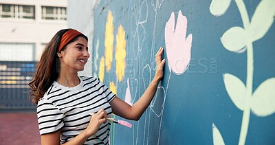 Buy stock photo Woman, smile or painting on wall for mural, drawing flowers or community service at building. Artist, outdoor or happy girl with brush for floral decoration, renovation project or aesthetic design