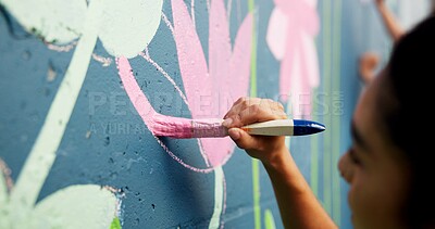 Buy stock photo Woman, hand or painting on wall art for mural, creativity or community service at building. Artist, paintbrush or outdoor with color for floral decor, creative process or flowers for aesthetic design