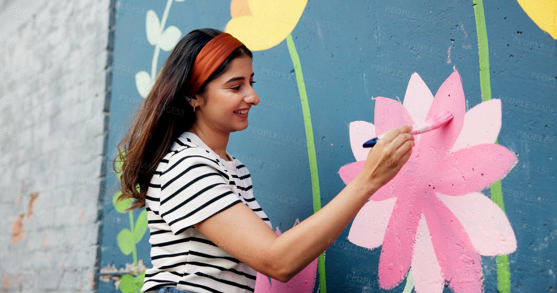 Buy stock photo Painting, mural and woman in city with flowers for art design, creative project and community service. Artist, happy and person with paintbrush outdoor for wall decor, inspiration and DIY hobby