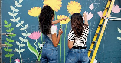 Buy stock photo Women, teamwork or planning painting on wall for mural, drawing flowers or community service at building. Artist, back or girls with ladder for floral decoration, renovation or project for design