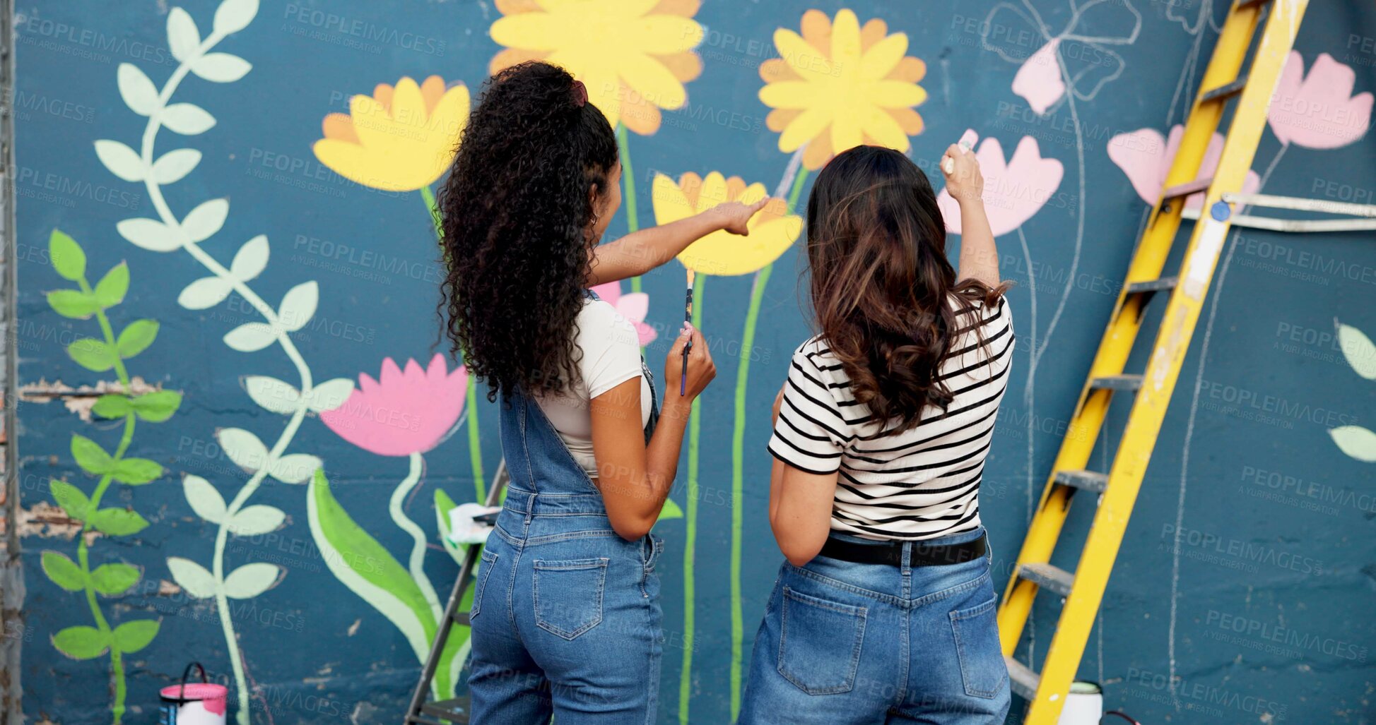 Buy stock photo Women, teamwork or planning painting on wall for mural, drawing flowers or community service at building. Artist, back or girls with ladder for floral decoration, renovation or project for design