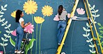 Back, women and painting mural for wall, ladder and community project with cooperation. People, outdoor and friends with creativity, expression and diy decor with flowers, student hobby and art
