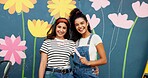 Mural, artist and women with paintbrush, outdoor and proud of decoration for wall and creative. Confident, painter and people with design in neighbourhood, portrait and community project in Canada