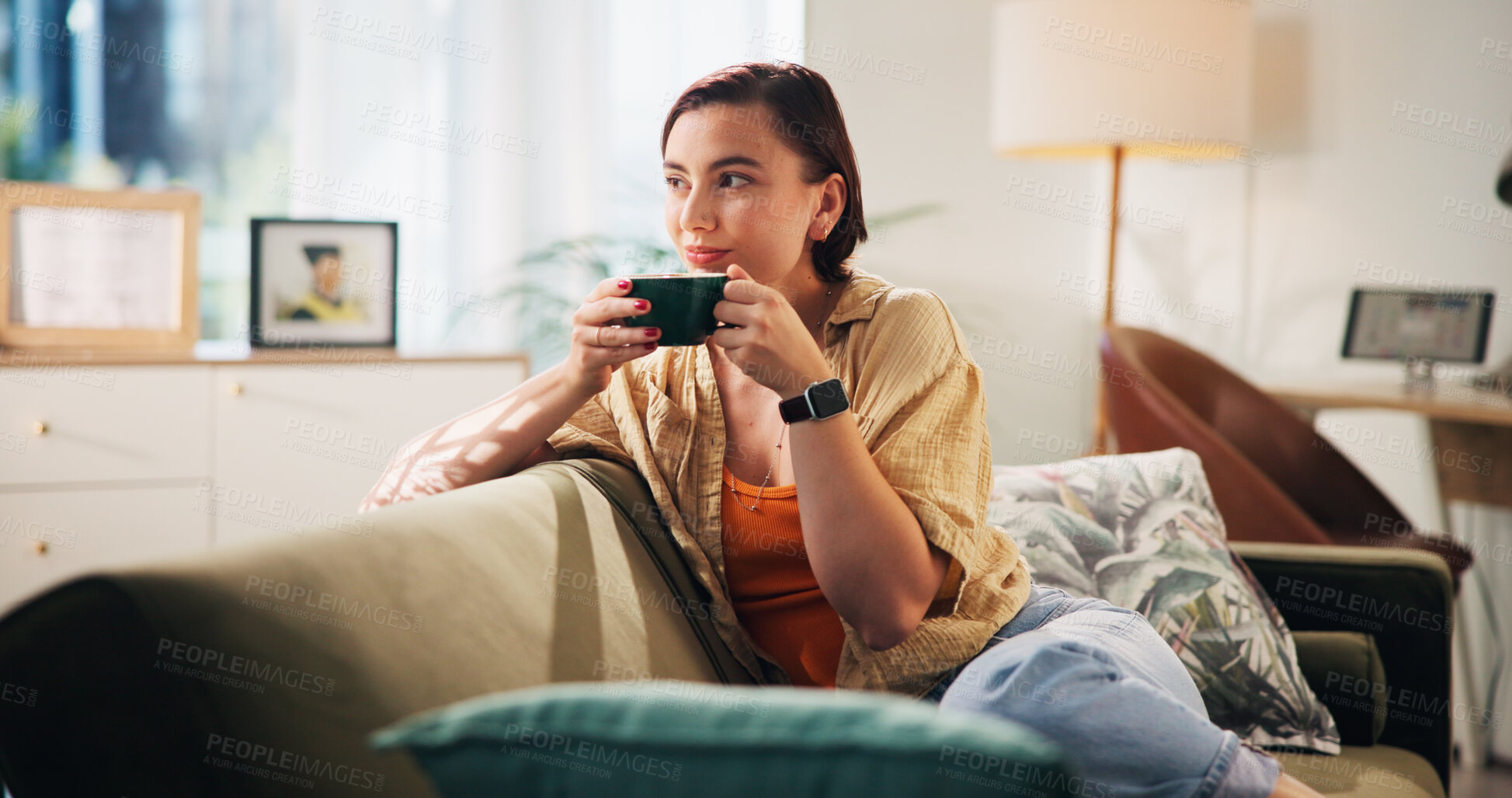 Buy stock photo Woman, relax and thinking on sofa with coffee, calm and stress free on weekend in home. Girl, female student and smile in living room with warm drink, comfort and me time on study break in apartment