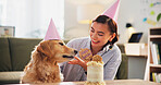 Birthday, cake and woman with dog happy for celebration, surprise and party together. Animal, pet owner and person with Golden Retriever with dessert or treats for adoption, anniversary and bonding