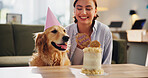 Birthday, cake and woman with dog in home for celebration, surprise and party together. Animal, pet owner and person with Golden Retriever with dessert or treats for adoption, milestone and bonding